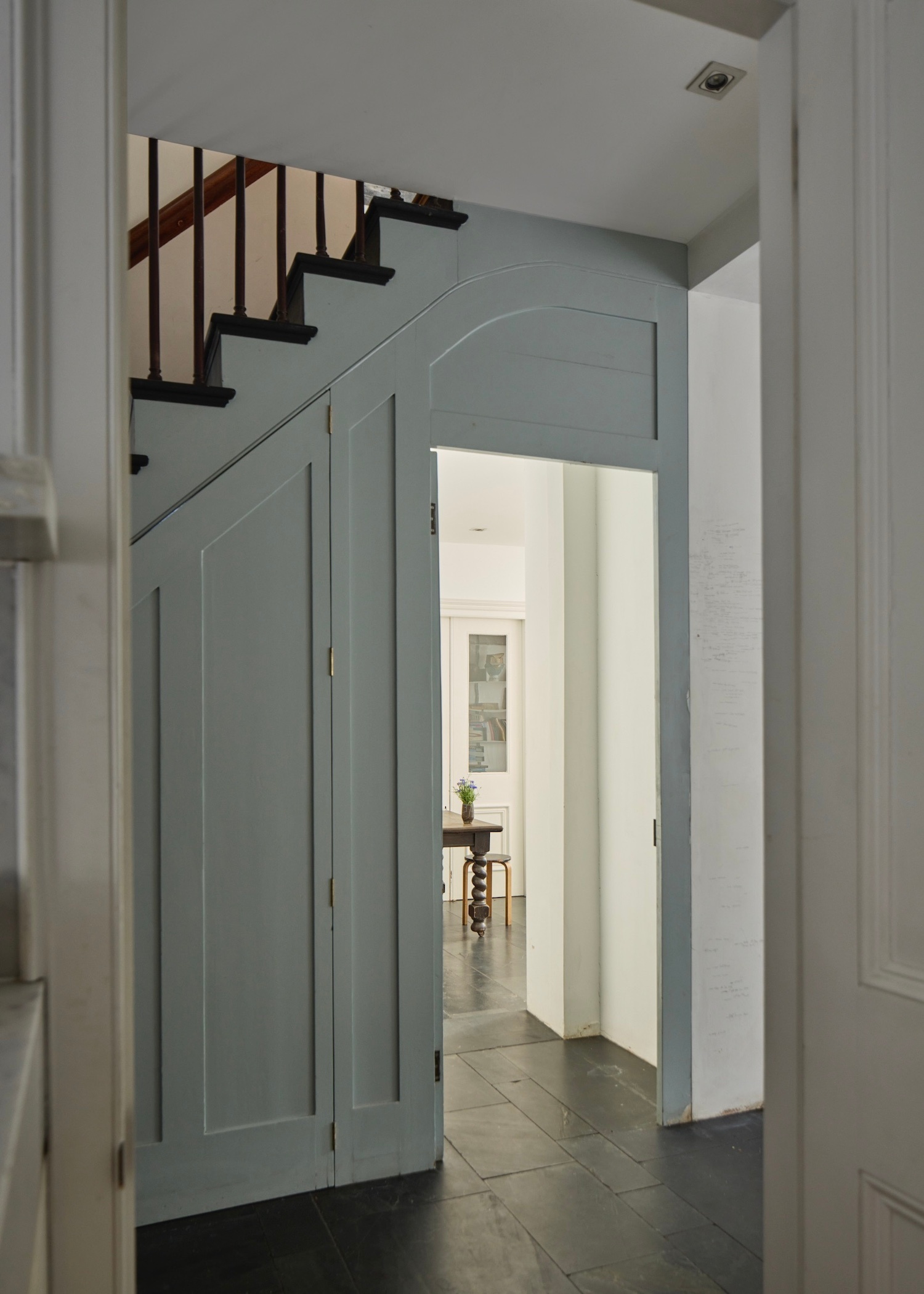 a view across slate flooring to a studio in a primrose hill house